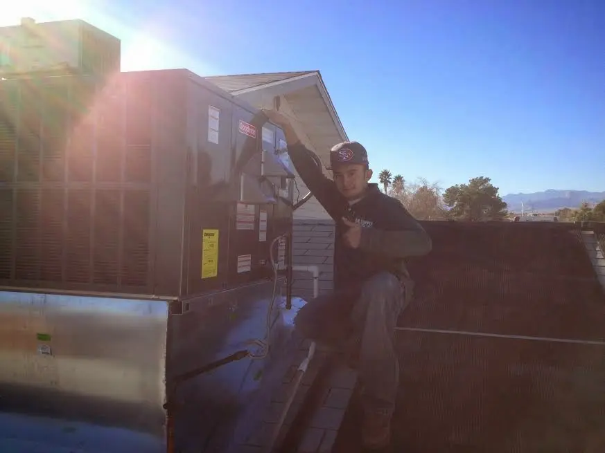 HVAC technician performing Boiler Repair on a rooftop unit in Gardnerville